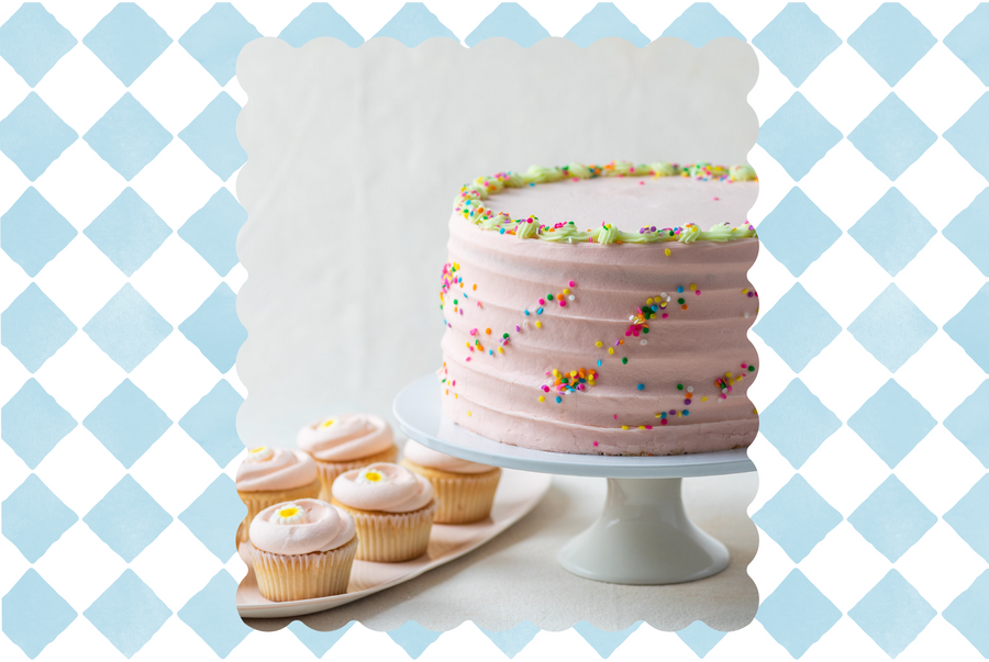 Cake on a stand with cupcakes